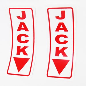 May include: Two white stickers with red borders and red lettering. Each sticker says "JACK" with a red arrow pointing down.