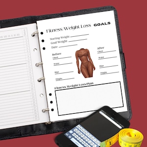 May include: A black and white planner with a section for fitness and weight loss goals. The planner includes a section for measurements before and after, as well as a section for a fitness plan. The planner is open to a page with a calendar.