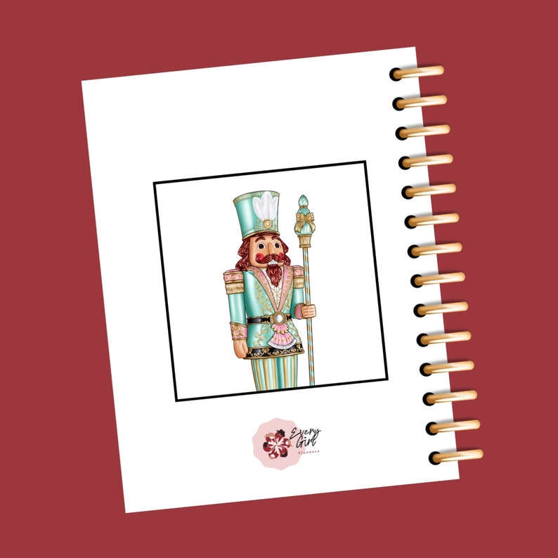 May include: A teal and gold nutcracker figurine with a red mustache and a white feather on his hat. The nutcracker is holding a gold and white staff. The image is framed in black and has a pink flower logo with the text "Every Girl Planner" at the bottom.