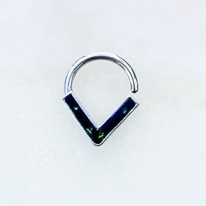 May include: A silver hoop earring with a black and green V-shaped design.