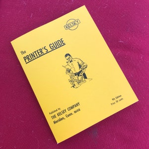 May include: A yellow booklet titled "The Printer's Guide" published by The Kelsey Company in Meriden, Connecticut. The cover features a black and white illustration of a man operating a printing press.