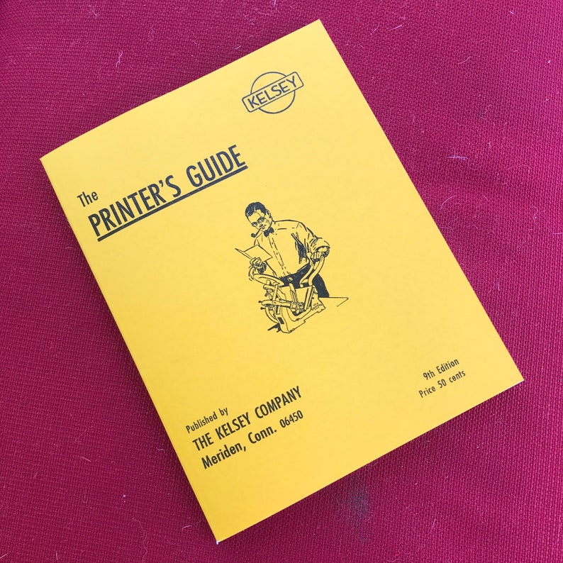 May include: A yellow booklet titled "The Printer's Guide" published by The Kelsey Company in Meriden, Connecticut. The cover features a black and white illustration of a man operating a printing press.