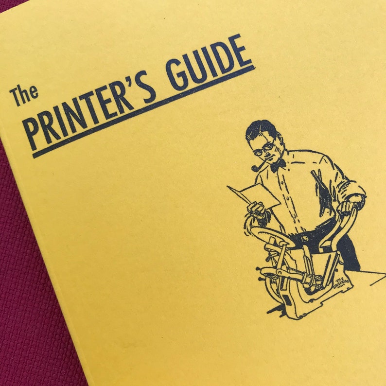 May include: A yellow book with the title "The Printer's Guide" in black text. The cover features a black and white illustration of a man operating a printing press.