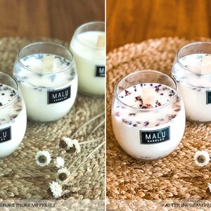 May include: Three glass candle jars with white wax and dried flower petals. The jars have black labels with the text "MALU CANDLES". The jars are sitting on a woven brown mat.