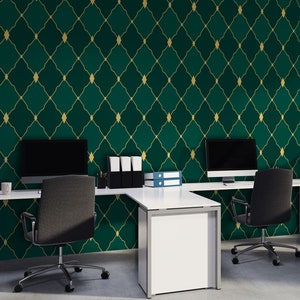 May include: A modern office workspace with two desks and chairs. The walls are covered in a green and gold geometric wallpaper pattern.
