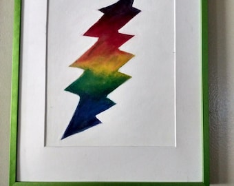May include: A framed artwork featuring a colorful lightning bolt design. The bolt transitions from dark purple to red, yellow, green, and blue. The artwork is framed in a green wooden frame with a white mat.