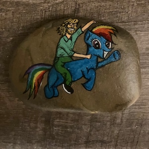 Trey Anastasio riding rainbow pony rock