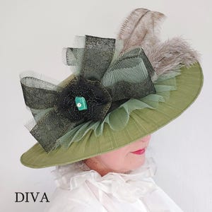 May include: A wide-brimmed, olive green hat with a decorative black flower and a turquoise gem in the center. The hat is adorned with black lace, green tulle, and feathers. The word "DIVA" is printed at the bottom.