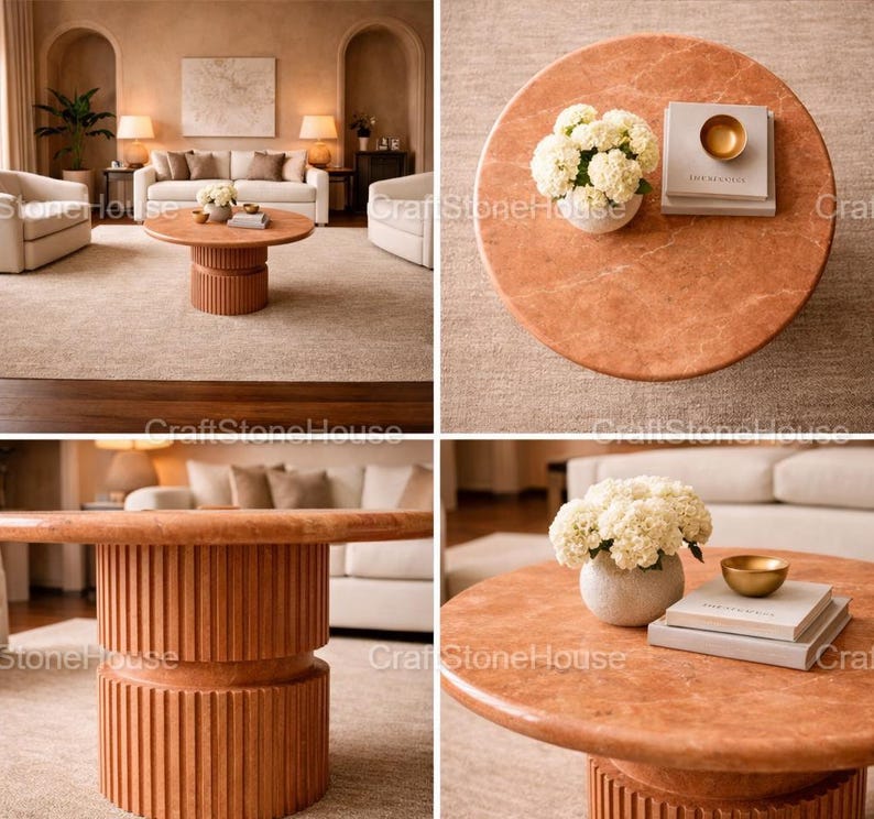May include: A circular, terracotta-hued coffee table with a ribbed base. The tabletop features a vase of white flowers, books, and a small gold bowl. The table is a focal point in a living room.