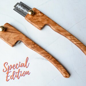 May include: Two wooden straight razors with a curved handle and a brass knob. One razor has a blade that reads "SHAVER SUPER STAIN". The words "Special Edition" are written in orange script.