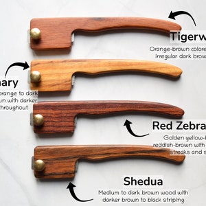 May include: Four wooden handles with different wood grain patterns and colors. The handles are labeled with the names of the wood types: Canary, Tigerwood, Red Zebrawood, and Shedua. Each wood type is described with its color and grain characteristics.