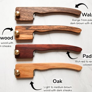 May include: Four wooden handles with brass accents, each handle is a different wood type: walnut, zebrawood, padauk, and oak. The wood types are labeled with their names and descriptions.