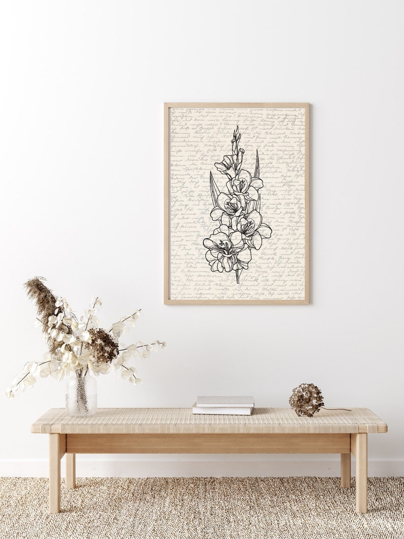 May include: A black and white line drawing of a flower with a vintage background. The drawing is framed and hanging on a white wall above a wooden bench.