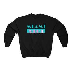 May include: Black sweatshirt with a teal and pink graphic that says "Miami Vice" in a retro font.
