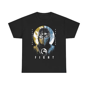 May include: A black short-sleeve t-shirt featuring a graphic print of two split faces, one yellow and one blue, representing Scorpion and Sub-Zero. The design includes the text SCORPION, SUB-ZERO, and FIGHT, along with a central dragon logo icon.