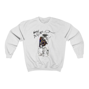 May include: White sweatshirt featuring a black and white illustration of a seated figure smoking a cigarette. The figure is wearing a hat, sunglasses, and a colorful shirt. The words "VINTAGE DR. GONZ" are printed above the figure.
