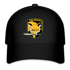 May include: Black baseball cap with a green, yellow and orange embroidered patch that says "FOX HOUND SPECIAL FORCE GROUP" and features a fox with a knife.