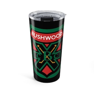 May include: A black stainless steel tumbler with a clear plastic lid. The exterior features a graphic emblem with the text BUSHWOOD in white letters, a large green letter B, and two crossed yellow golf clubs on a black, red, and green background.