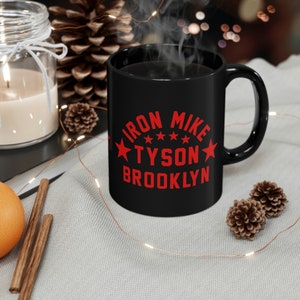 May include: Black coffee mug with a red graphic that says "Iron Mike Tyson Brooklyn" with five red stars.