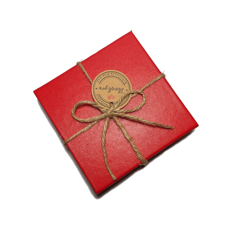 May include: A red gift box tied with twine and a brown paper tag that says "Thank you" with a heart.