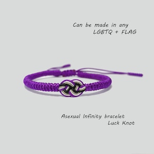 May include: Purple infinity bracelet with a black, white, and gray knot. The bracelet is made with a knot that is also known as a luck knot. The text "Asexual Infinity bracelet Luck Knot" is below the bracelet. The text "Can be made in any LGBTQ + FLAG" is above the bracelet.