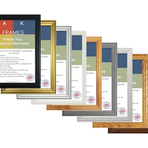 May include: A row of eight picture frames in different colours and wood finishes. The frames are all the same size and style, with a simple, classic design. The frames are arranged in a row from left to right, with the black frame on the left and the brown frame on the right. The text "A K FRAMES Frame Your Colourful Memories" is visible on the black frame. The text "Frames can be displayed Landscape or Portrait" is also visible on the black frame.