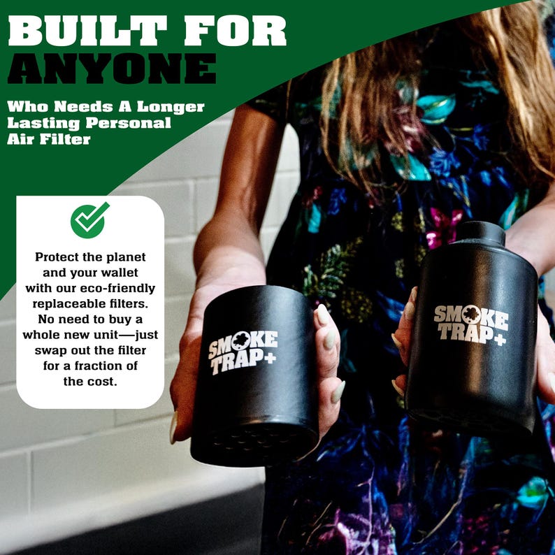 May include: Two black cylindrical air purifiers with the text "Smoke Trap+" in white. The purifiers are being held by a person wearing a floral dress.