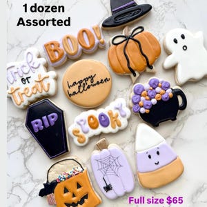 May include: An assortment of Halloween-themed sugar cookies including a black witch hat, orange pumpkin, white ghost, black cauldron with purple bubbles, black coffin with RIP, and a candy corn. Text reads 1 dozen Assorted, happy halloween, and SPOOKY.