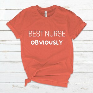 May include: A coral orange t-shirt with the text "BEST NURSE OBVIOUSLY" in white.