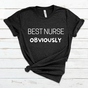 May include: A dark grey t-shirt with the text "BEST NURSE OBVIOUSLY" printed in white.