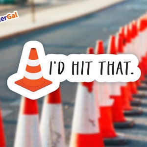 May include: A die-cut sticker featuring a bright orange and white traffic cone graphic positioned to the left of the black text that reads I'D HIT THAT. The sticker has a white border and is displayed against a blurred background of road cones.