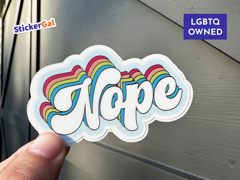 May include: A rainbow-colored sticker with the word "Nope" in white, with the text "LGBTQ OWNED" in the upper right corner.