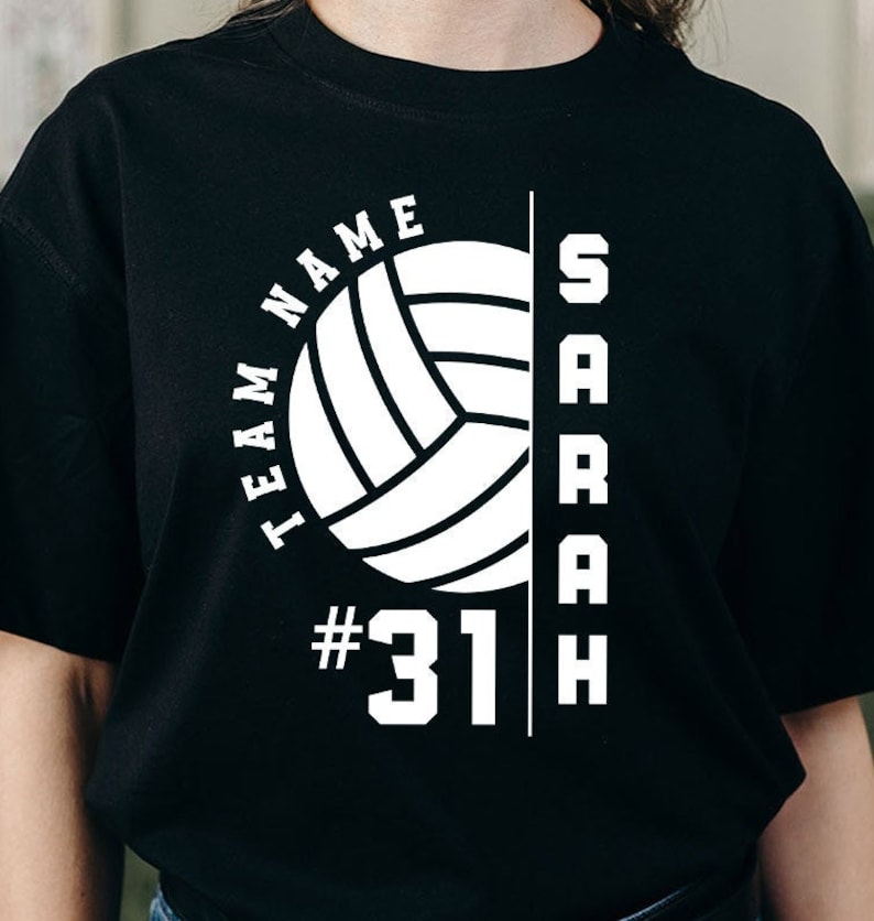 May include: Black t-shirt with a white volleyball graphic, the text "TEAM NAME" and "SARAH", and the number "31".