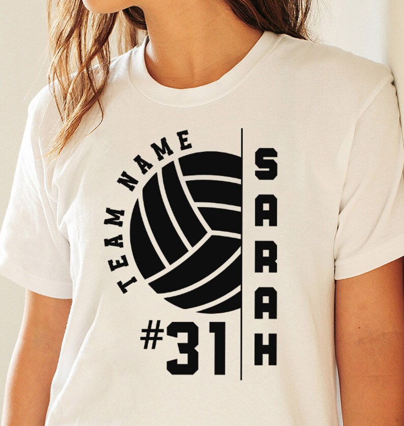 May include: White t-shirt with a black volleyball graphic, the text "TEAM NAME" and "SARAH" and the number "#31"