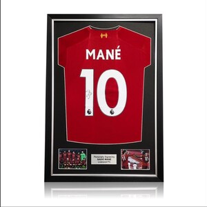 May include: Framed red football shirt with the name "MAN&Eacute;" and number "10" on the back. The shirt is signed by Sadio Man&eacute;, a player for Liverpool FC.