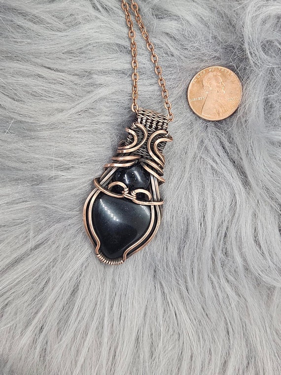 Black Onyx wrapped in copper wire with star-lit blue goldstone accent