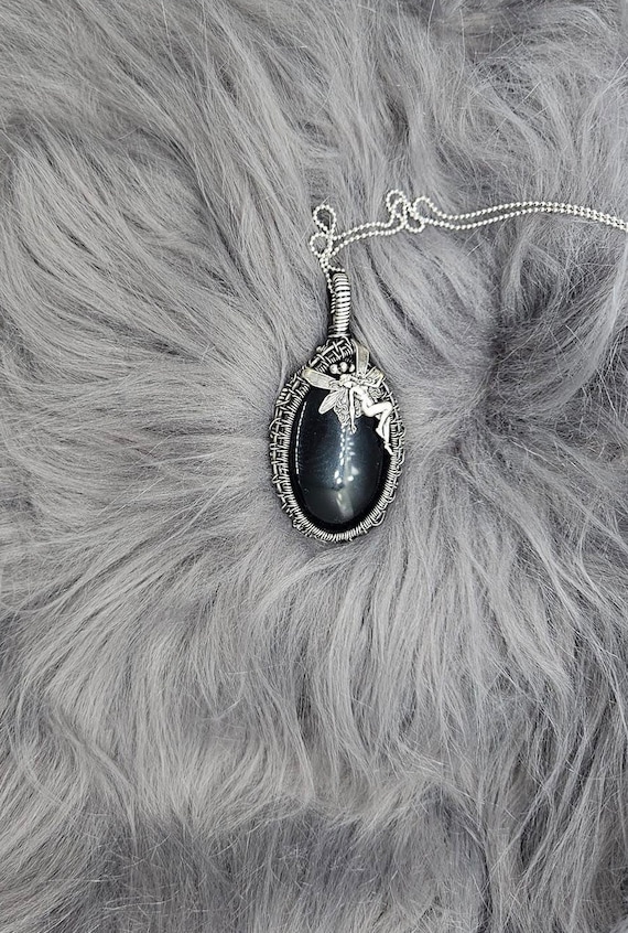 Protective Black Onyx wrapped in solid sterling silver with a whimsical fairy silver charm and solid .925 sterling box chain included.