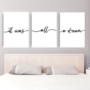 May include: Three white framed prints with black calligraphy text. The text reads "it was all a dream".