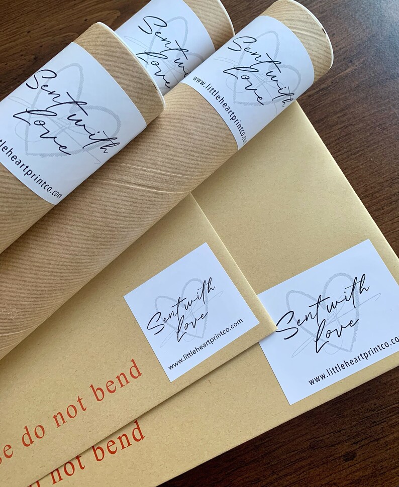 May include: Three brown cardboard tubes with white labels that say "Sent with Love" and the website address "www.littleheartprintco.com". The tubes are on a brown surface with the text "Do not bend" printed in red.