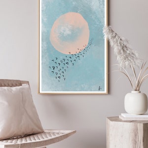 May include: A framed abstract art print with a large pink circle and a trail of black birds flying in a curved line against a light blue background.