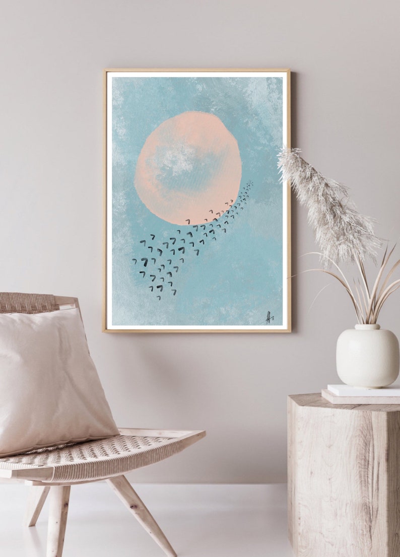 May include: A framed abstract art print with a large pink circle and a trail of black birds flying in a curved line against a light blue background.