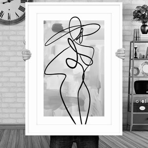 May include: A black and white line drawing of a person with a hat, on a background of abstract gray and white brushstrokes.