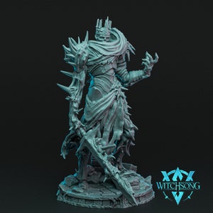 May include: A gray 3D printed miniature of a skeletal figure wearing a crown and armor, holding a sword. The figure is standing on a circular base with a textured surface. The miniature is labeled "WITCHSONG".