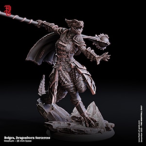 May include: A detailed miniature figurine of a dragonborn sorceress, painted in bronze and brown tones. She is wearing armor and wielding a staff with a spiked orb at the end. The base is made of textured gray rock.