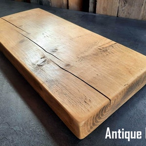 May include: A rustic wooden shelf made from antique pine. The shelf has a natural wood finish and shows signs of age and wear.