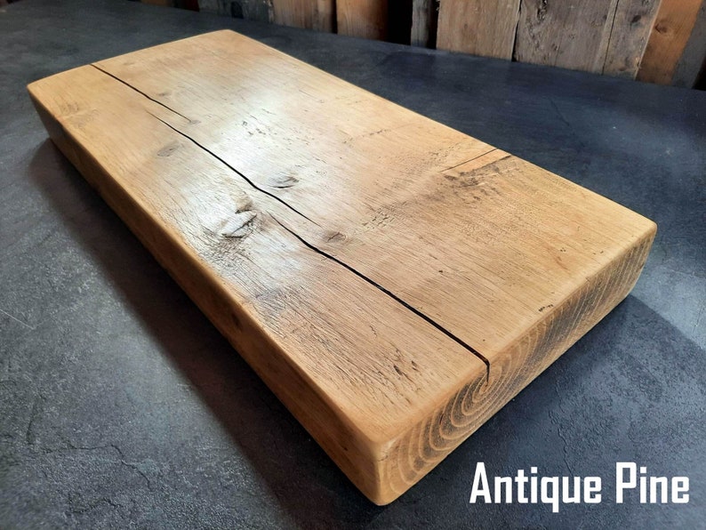 May include: A rustic wooden shelf made from antique pine. The shelf has a natural wood finish and shows signs of age and wear.