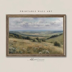 May include: A framed landscape wall art print featuring a rolling green valley under a cloudy sky. The text reads: Those who hope in the Lord will renew their strength. They will soar on wings like eagles. Isaiah 40:31. The frame is a metallic bronze colour.