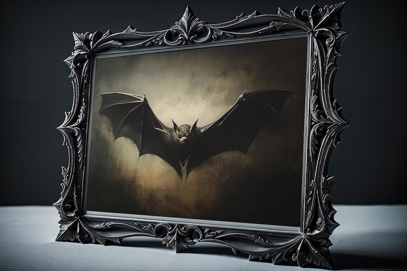 May include: A black and white framed print of a bat with its wings spread wide, flying against a dark, textured background.