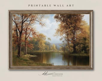 May include: A framed landscape painting featuring a calm river flowing through a forest with autumn foliage in shades of gold, orange, and brown. The scene includes tall trees on both banks, a grassy shoreline, and a soft, cloudy sky above.