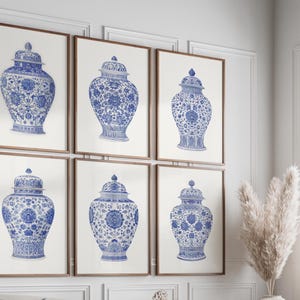 May include: Six framed prints of blue and white decorative vases with lids. The vases feature intricate floral patterns and are displayed against a neutral background. The frames are a warm brown color, adding a touch of elegance to the wall decor.